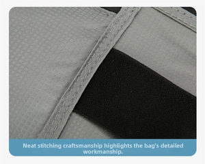 Close-up of gray ripstop fabric and reinforced black elastic band on sports waist bag