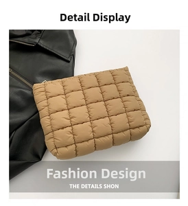 Detail view of the brown quilted square stitching texture on a minimalist cotton clutch bag