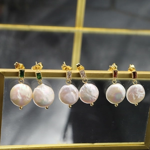 Baroque pearl earrings with emerald crystal in gold setting on minimalist stand