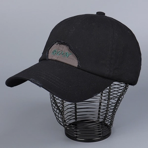 Distressed black cotton baseball cap with green R-U-N letter embroidery and vintage holes