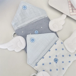 Close-up of star pattern mini pouches with plush angel wings and snap closure