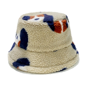 Detailed close-up of soft beige plush bucket hat featuring colorful dog pattern texture