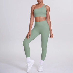Detail of one-shoulder yoga bra and high-waist mint green leggings set on model