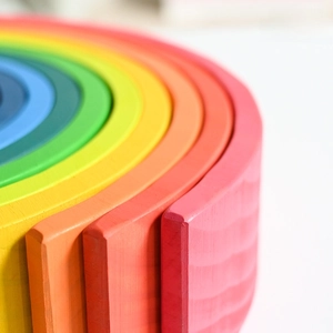 Handcrafted wooden rainbow stacking blocks toy with natural wood grain texture for toddlers