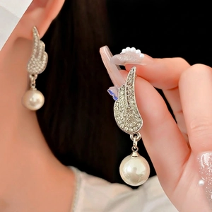 Elegant silver wing earrings with sparkling crystals and large white pearls for women
