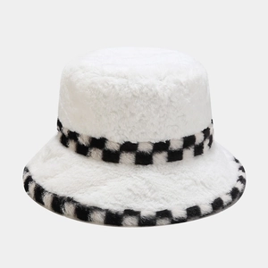 Close-up of plush white bucket hat featuring a trendy black and white checkered trim detail