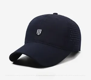 Detail of dark blue baseball cap showing laser-cut side vents and silver shield logo