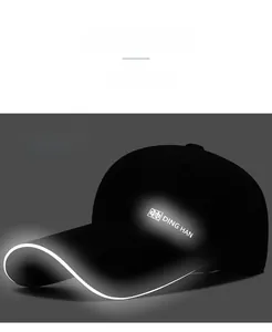 Detail of black baseball cap showing night reflective coating on logo and long brim