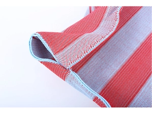 Macro shot of red and light blue striped knit fabric showing detailed texture and edging