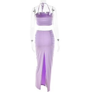 Rear view of purple halter crop top and long skirt with high slit on transparent mannequin