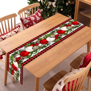 Christmas table runner with red black plaid edges, ornaments and pine cone patterns