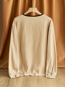 Detailed back view of linen Henley shirt showing fabric texture on wooden hanger