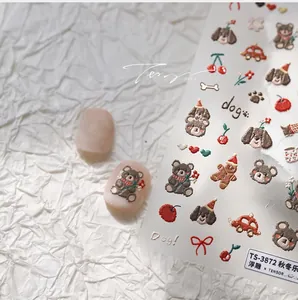 Detail of 3D embossed nail stickers featuring brown bears and gingerbread man designs