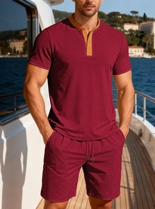 Close-up of wine red men's polo set showing premium knit texture on a yacht