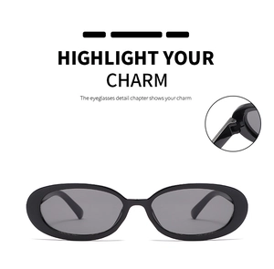 Detail view of oval sunglasses featuring the durable metal screw hinge and black frame