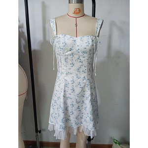Detail of adjustable shoulder straps and sweetheart neckline on a floral mini dress