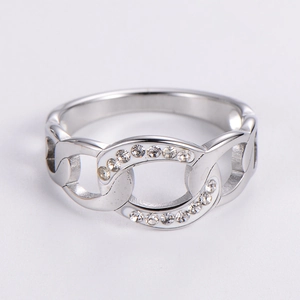 Macro shot of silver hollow chain ring with sparkling pave-set zircons on white backdrop