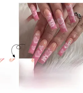 Detail of pink coffin press-on nails with white heart and star gradient patterns