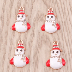 Detailed macro view of four snowman charm pendants with red enamel and crystals