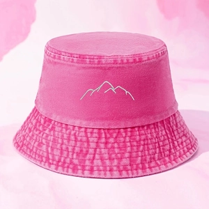 Pink washed canvas bucket hat featuring white embroidered mountain peak design for daily wear