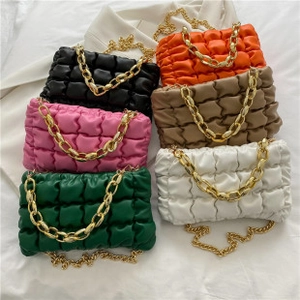 Collection of cloud-shaped pleated bags in six vibrant colors with chunky gold chains