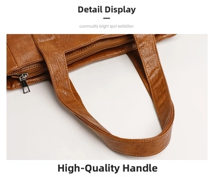 Close-up of brown faux leather tote bag showing neat stitching and silver zipper detail