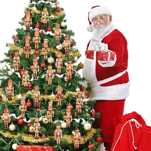 Nutcracker wooden ornaments hanging on a Christmas tree with Santa holding a gift box
