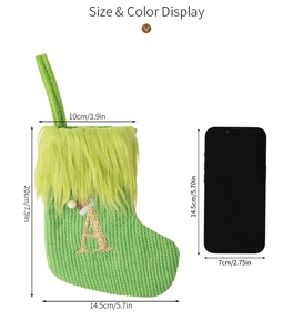 Size display of green knitted Christmas stocking with gold letter A embroidery and plush trim
