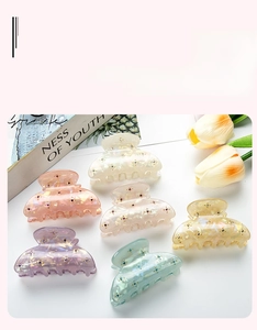 Detail of 6cm starburst hair claw clips in pastel colors with sparkling rhinestones