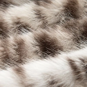 Macro shot of high-quality faux fur texture in striped taupe and white tones