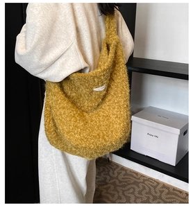 Detail of the ginger yellow plush tote bag showing its soft faux fur texture and wide strap