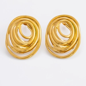 Macro detail of golden hollow spiral hoop earrings with polished metallic texture