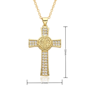 Macro view of gold cross necklace with clear zircons and religious medallion details