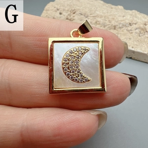 Detailed close-up of a square gold pendant with mother of pearl and zircon moon inlay