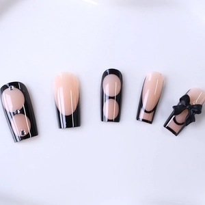 Long press-on nails with black French tips, 3D bows and rhinestone butterfly accents