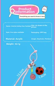 Detail view of acrylic football keychain with pink braided cord and smiling face charm