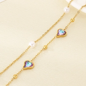 Luxurious 18K gold heart anklet with shimmering stones and elegant pearl accents