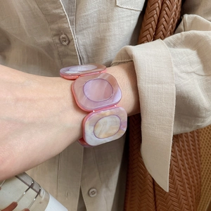 Detail of a resin square block stretch bracelet with purple marble pattern on a wrist