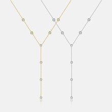 Detail of Y-shaped gold and silver necklaces featuring multiple sparkling zircon stones