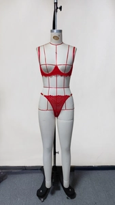 Detailed front view of red lace lingerie set featuring eyelash trim on a studio mannequin