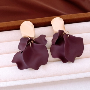 Detail shot of burgundy acrylic petal drop earrings with gold irregular metal studs