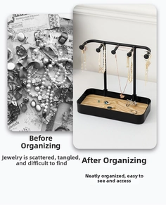 Detail of a two-tier black metal jewelry rack with a wooden base for necklaces and rings