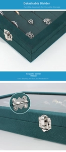 Detail of dark green velvet jewelry box featuring metal hinges and removable dividers