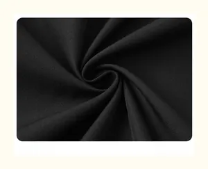 Detailed close-up of high-quality black fine-woven fabric with smooth drape and texture
