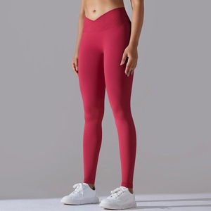 Close-up of red high-waisted yoga pants with V-cross waistband and seamless knit texture