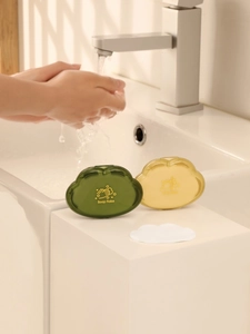 Portable dark green and yellow soap flake boxes shown in a clean bathroom setting