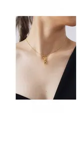 Detailed close-up of a 3D bunny pendant on a minimalist 18K gold-plated titanium chain