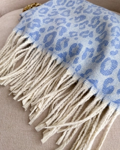 Close-up of blue leopard print cashmere scarf featuring off-white fringe tassel details