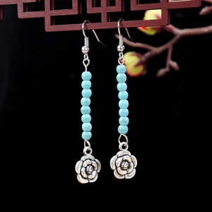 Ethnic vintage turquoise drop earrings with silver flower charms and blue beads
