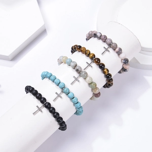 Detail of beaded stretch bracelets with cross pendants in various natural stones